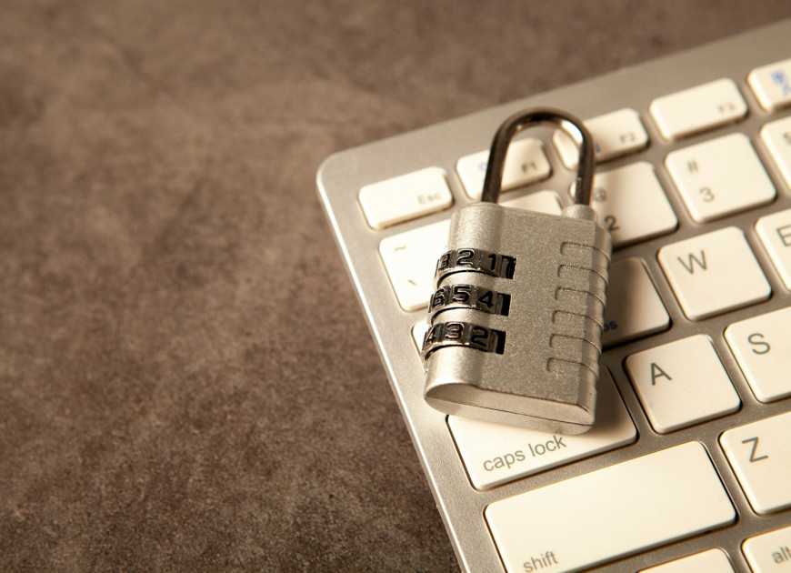 A padlock rests on a computer keyboard