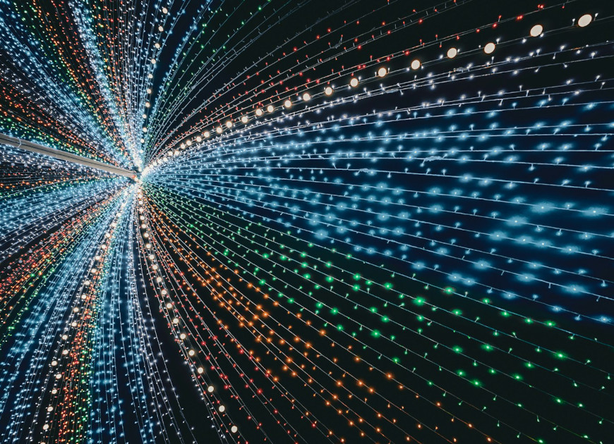 A very large tunnel of lights in the middle of a room